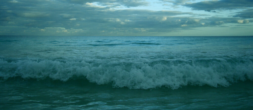 Waves crashing on the beach in the evening
