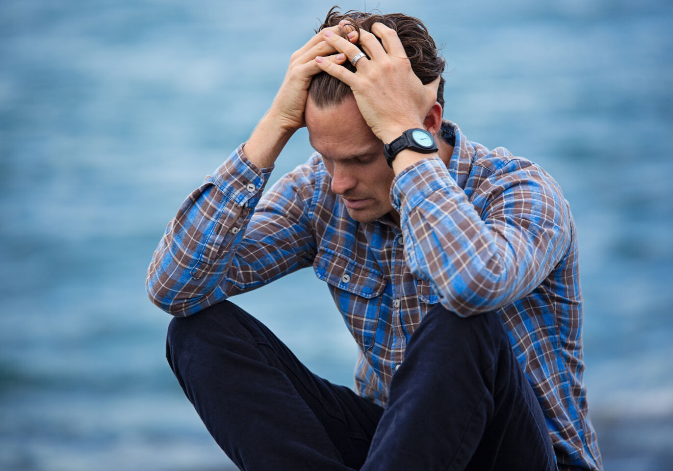 Man upset on dock overlooking a lake Man upset on dock overlooking a lake